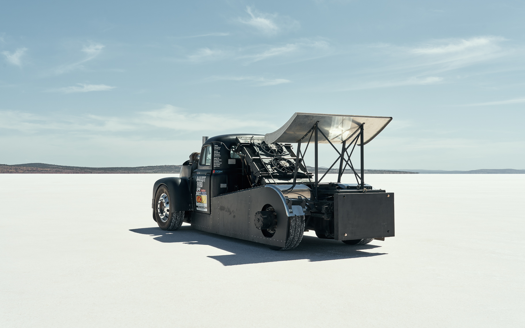 A modified truck sits on a salt lake